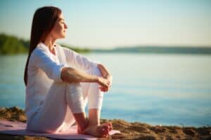 The Impact of Workplace Stress on Overall Well-being. Relaxed-woman-enjoying-sea.